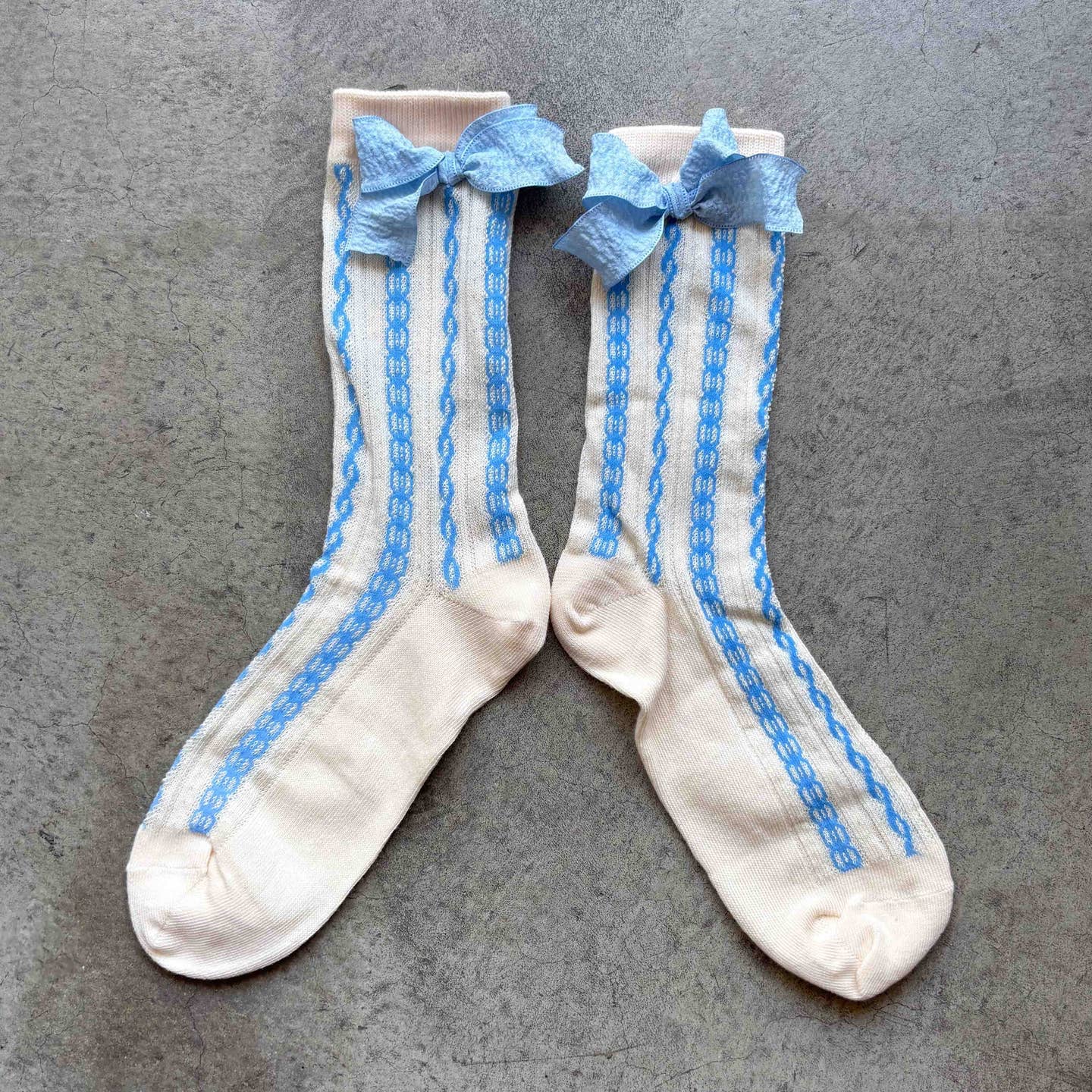 Elevate any outfit with these elegant sheer crew socks featuring delicate vertical knit detailing and a soft, textured ribbon bow. The semi-sheer design adds a feminine, vintage-inspired touch while remaining comfortable for everyday wear.