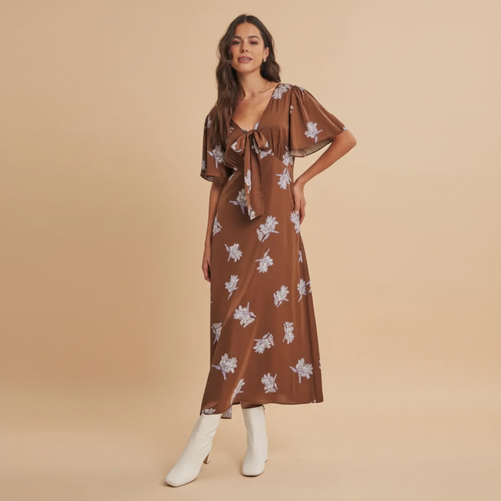 Embrace effortless elegance with this Soft Dusk Silky Floral Midi Dress. The luxurious silky fabric drapes beautifully in warm brown florals, creating a romantic and refined look. Its slim-fitting silhouette flatters your figure while the midi length offers versatile styling for any occasion—from casual outings to special gatherings. Perfect for those who appreciate timeless pieces that feel as good as they look.