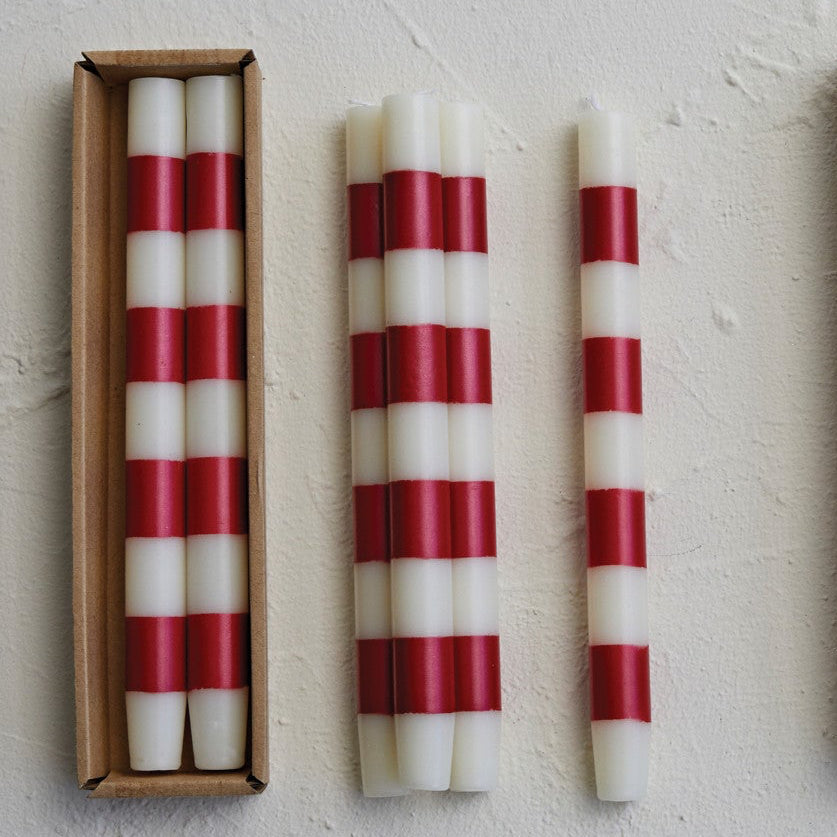 Set the mood with our Unscented Taper Candles featuring playful stripes. Includes a set of two candles in a convenient box. No need for overpowering scents, just enjoy the warm, flickering light. Perfect for any occasion, without taking itself too seriously. Red & White Striped