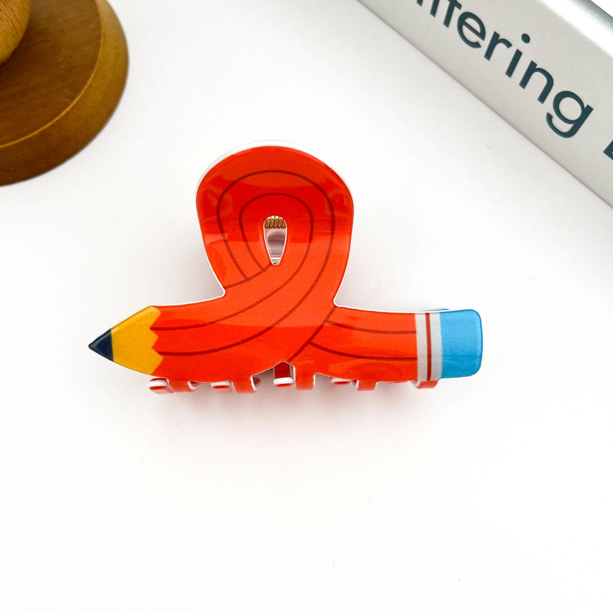 Add a creative twist to your hairstyle with this Cartoon Pencil Hair Claw Clip, designed to look like a fun and colorful pencil! With its quirky, school-inspired shape and bold cartoon detailing, this clip brings a touch of whimsy to your everyday look. Made from sturdy, lightweight material with a strong grip, it’s perfect for holding hair in place while expressing your playful personality. Great for students, teachers, or anyone who loves unique, conversation-starting accessories!