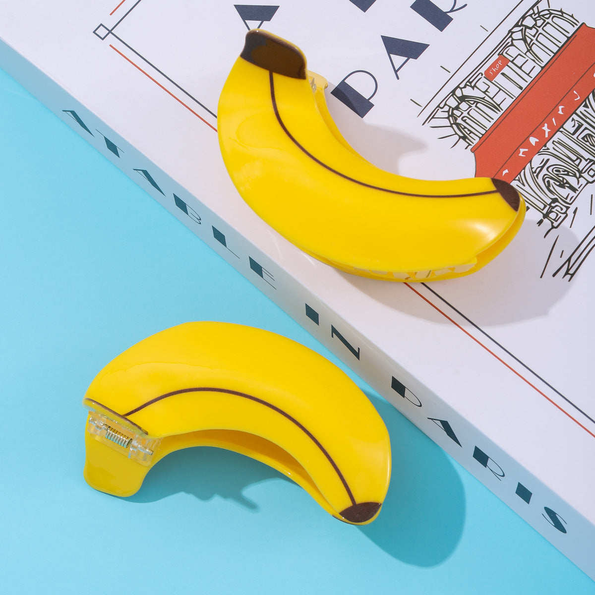 Add a fun and fresh pop of color to your hairstyle with these cute banana-shaped hair clips. Featuring a vibrant yellow finish and realistic fruit detailing, these clips bring a playful, summery vibe to any look.

Equipped with a sturdy spring clasp, they offer a secure and comfortable hold for medium to thick hair, perfect for daily wear or adding a quirky touch to your outfit. Stand out from the crowd with this adorable fruit-inspired accessory!