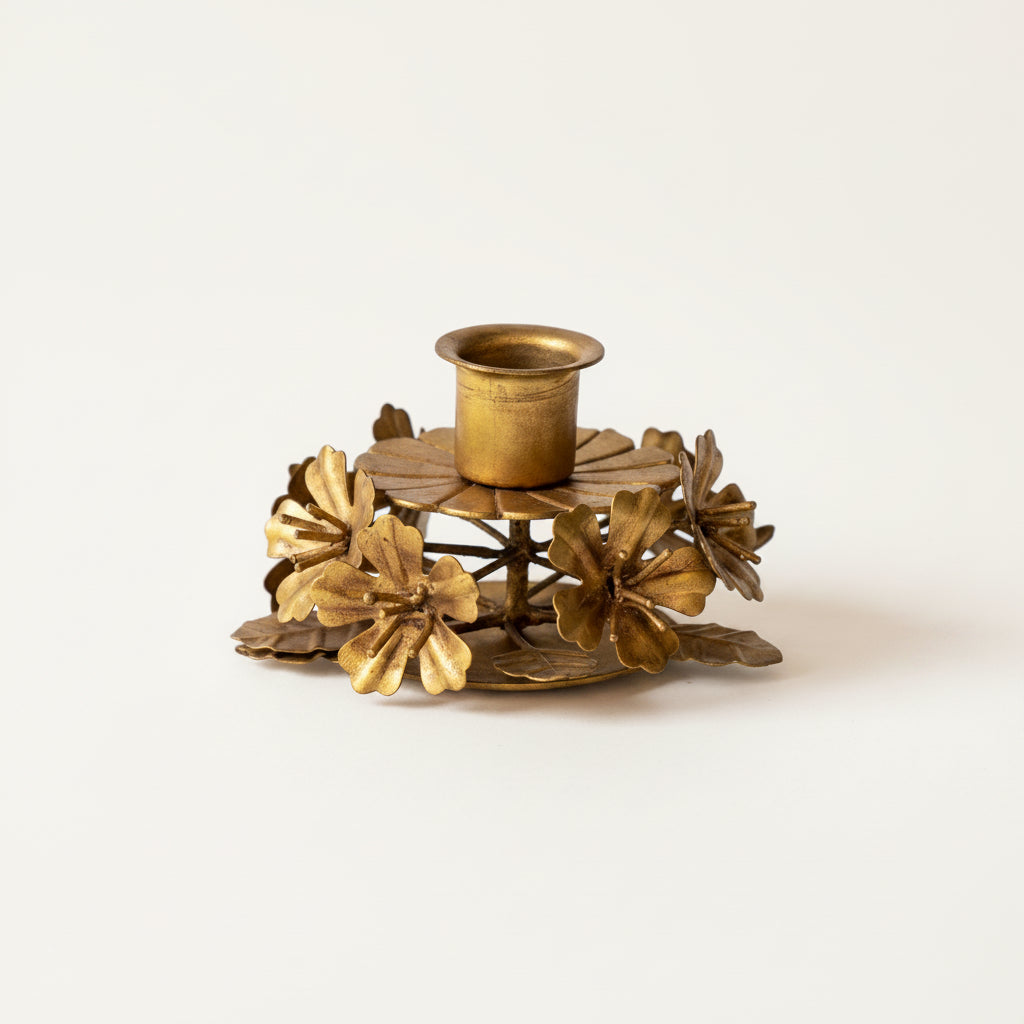 Add a touch of vintage elegance and cozy warmth to your home with this beautiful botanical toleware taper holder. Featuring delicate metal leaves and flowers, it provides a charming accent piece to create a welcoming and serene atmosphere in any space.