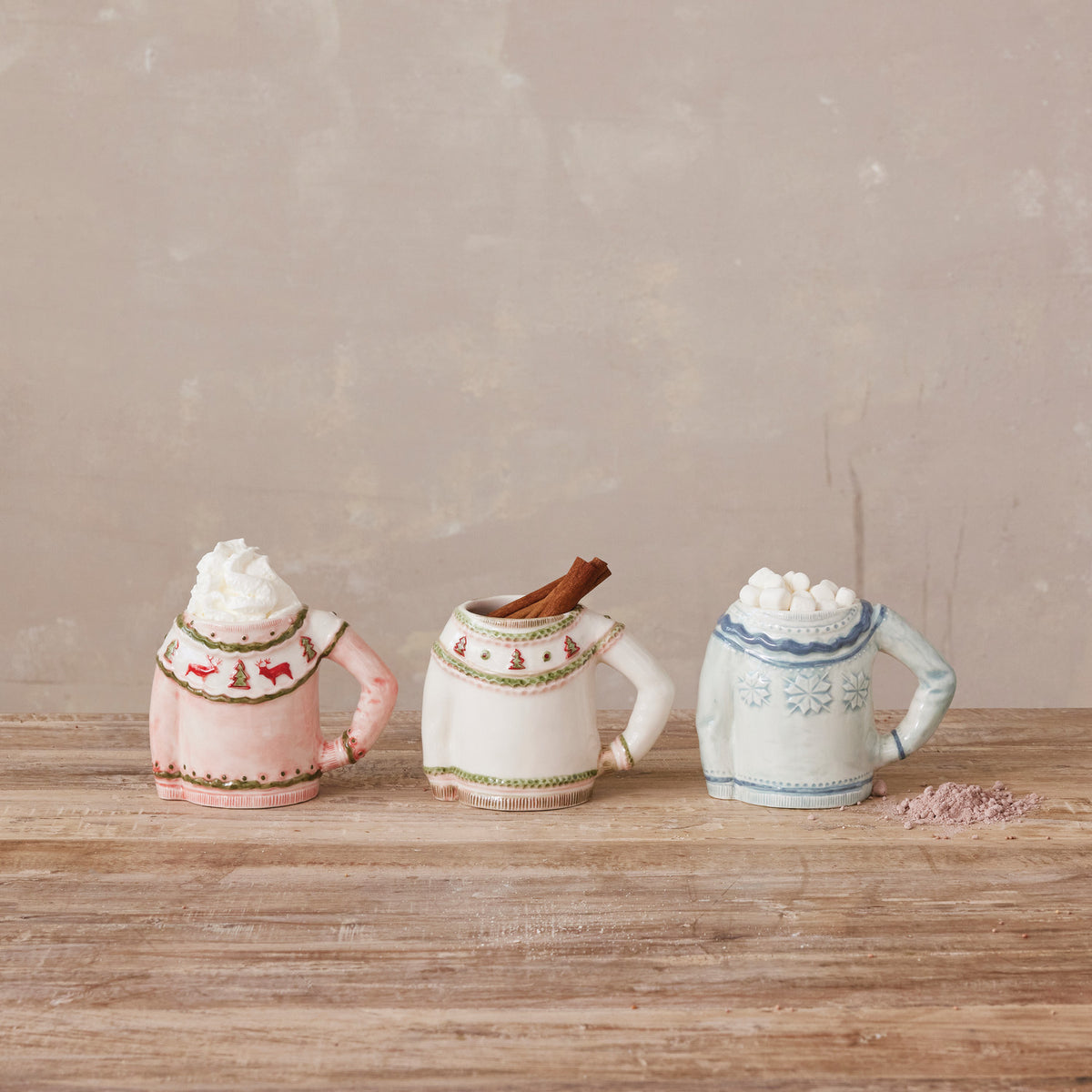Cozy up with your favorite hot drink in this charming 14 oz. stoneware sweater-shaped mug. Featuring a textured sweater design and available in three delightful styles, it brings extra comfort and festive warmth to every soothing sip.