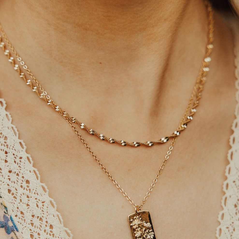 The Amelia Gold Filled Twist Necklace is the perfect piece to stack with other&nbsp;necklaces or wear as a stand alone accessory. She’s 18k gold filled, tarnish and wear resistant, and made to last. Hypoallergenic and nickel free, this unique and dainty 3mm chain is the perfect accessory all year long.&nbsp;16" length.