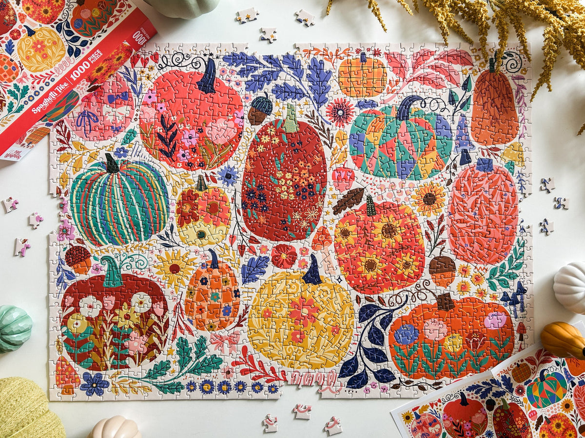 Above view of patchwork pumpkins puzzle. Graphics done in a patchwork style. Lots of cheerful pumpkins with cute and quirky designs. 
