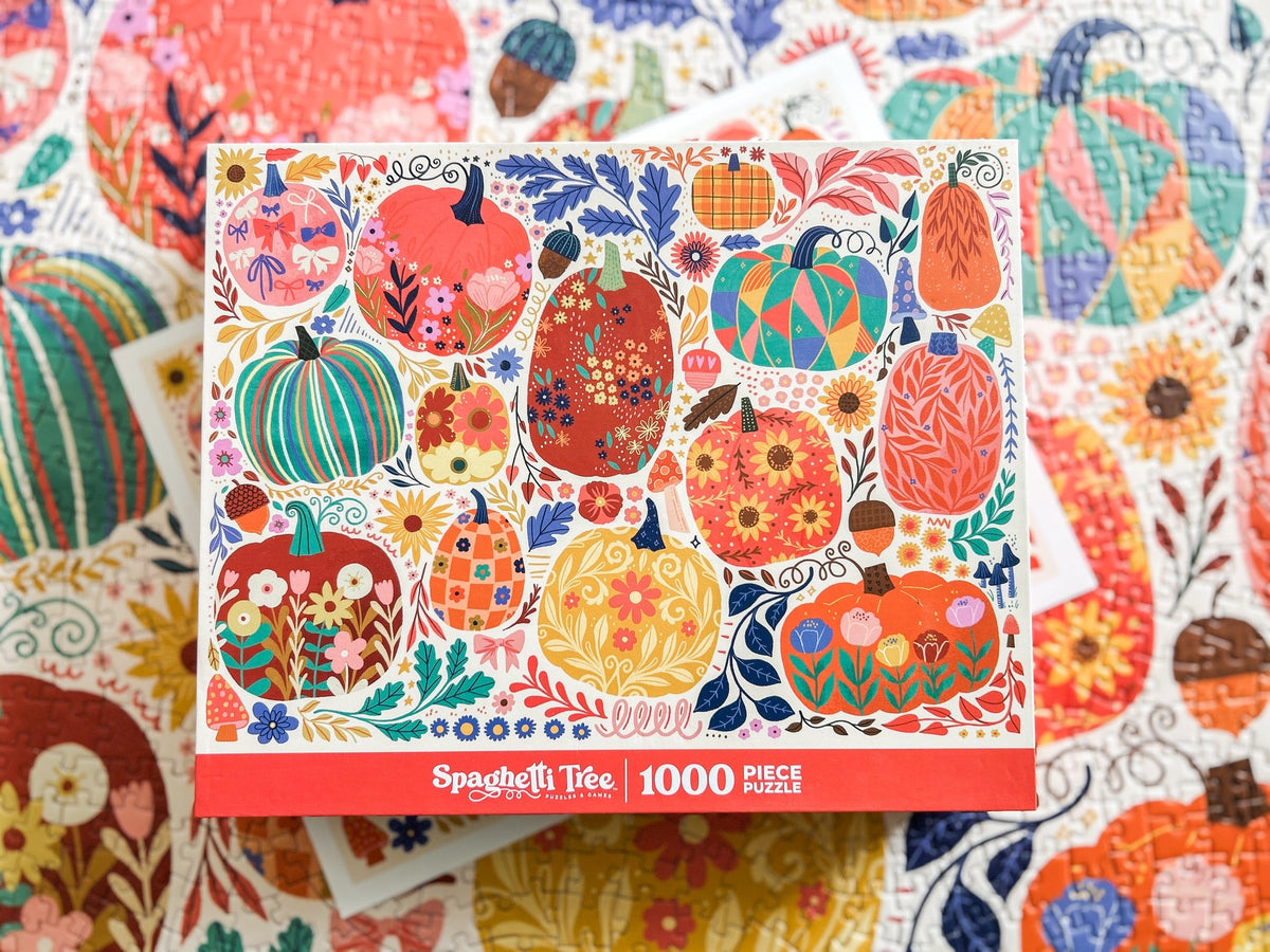 Above view of patchwork pumpkins puzzle. Graphics done in a patchwork style. Lots of cheerful pumpkins with cute and quirky designs. 