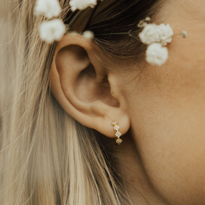 These Alice Diamond hoops are the perfect accessory to complete any outfit. They are sterling silver based gold vermeil and are hypoallergenic, tarnish and wear resistant, and perfect for sensitive ears. They measure a dainty 10mm and are perfect for a first piercing or in an earring stack. Gold