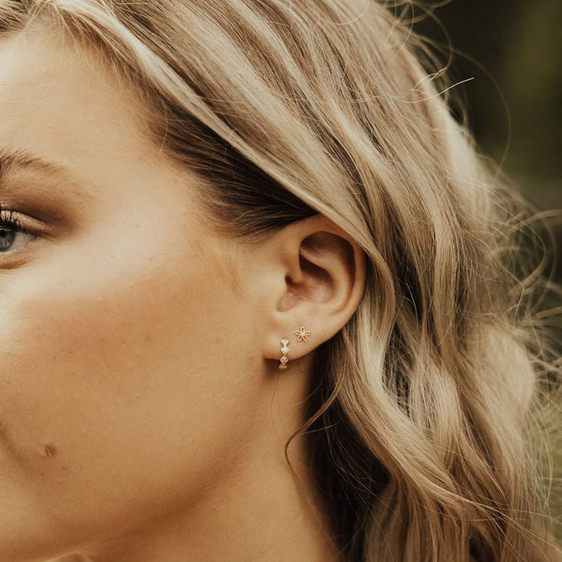 These Alice Diamond hoops are the perfect accessory to complete any outfit. They are sterling silver based gold vermeil and are hypoallergenic, tarnish and wear resistant, and perfect for sensitive ears. They measure a dainty 10mm and are perfect for a first piercing or in an earring stack.