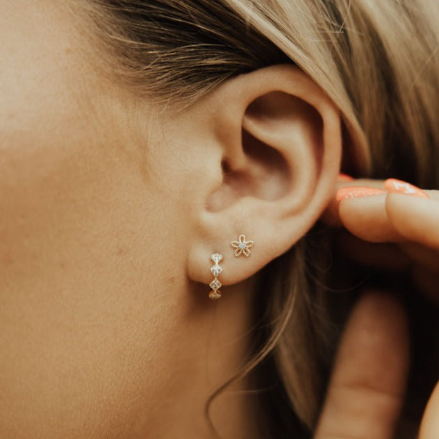 These Alice Diamond hoops are the perfect accessory to complete any outfit. They are sterling silver based gold vermeil and are hypoallergenic, tarnish and wear resistant, and perfect for sensitive ears. They measure a dainty 10mm and are perfect for a first piercing or in an earring stack.