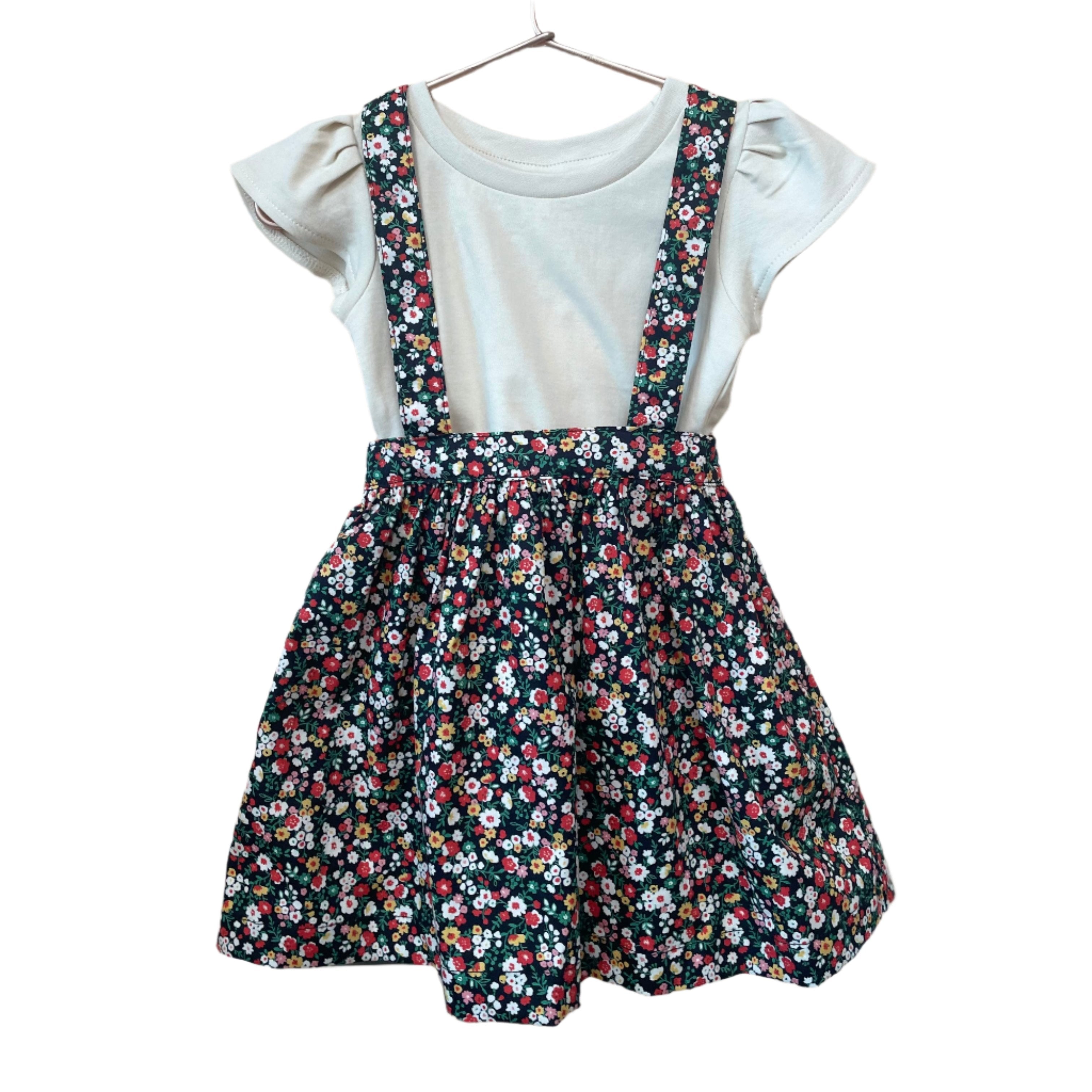 The Andi mini trouser skirt has adjustable suspenders with a button on the back. Two button holes are sewn on each suspender strap so your child can grow with their skirt making it easy to wear high on her waist when they are younger &amp; on their natural waist when older