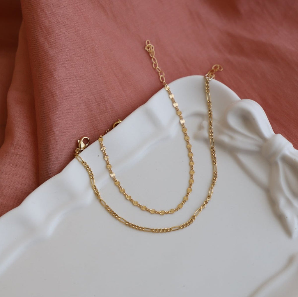 Delicate and modern, the Delicate Figaro Chain is crafted with gold filling for a sleek look. With its intricate design and high-quality materials, Figaro is a must-have for any fashion-forward individual.