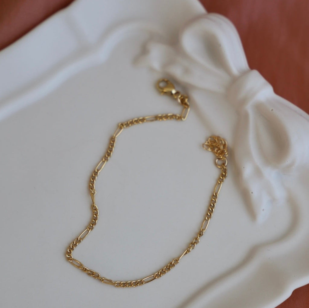 Delicate and modern, the Delicate Figaro Chain is crafted with gold filling for a sleek look. With its intricate design and high-quality materials, Figaro is a must-have for any fashion-forward individual.