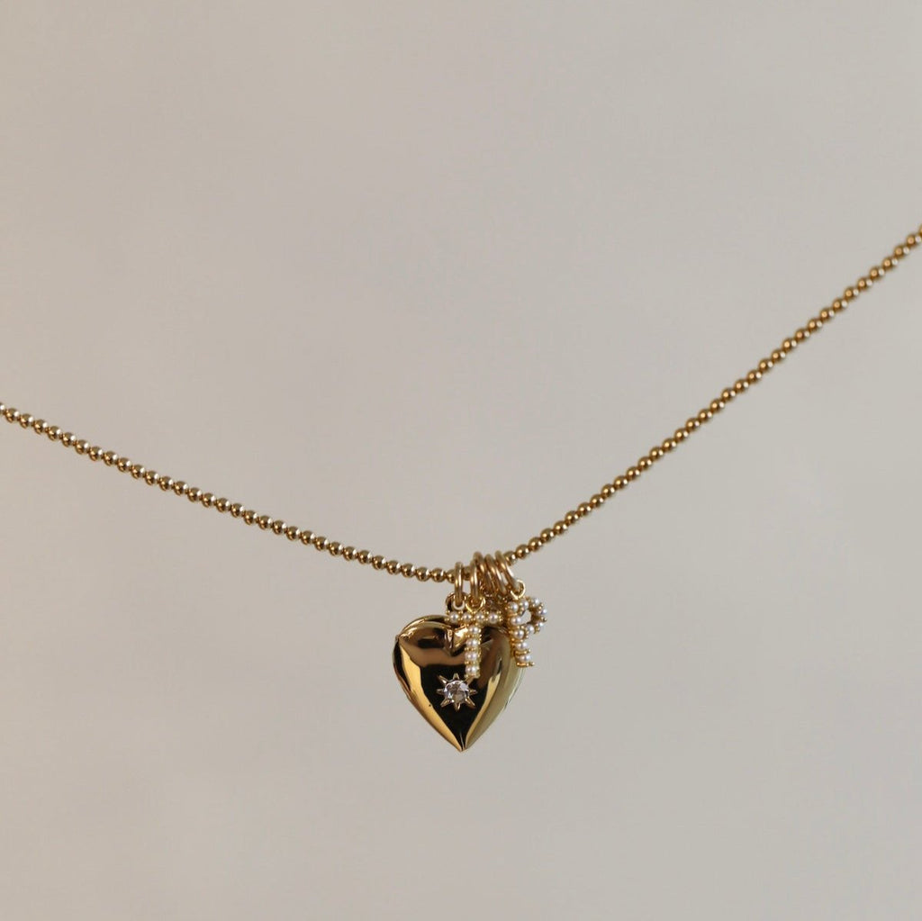 Add a sentimental touch to your charm necklace with our heart locket charm. Keep your loved ones close to your heart with this charming addition. It makes the sweetest gift and the perfect way to show someone you care. We love pairing it with our Gold Filled Beaded Chain or adding it to our Nova Chain Necklace.