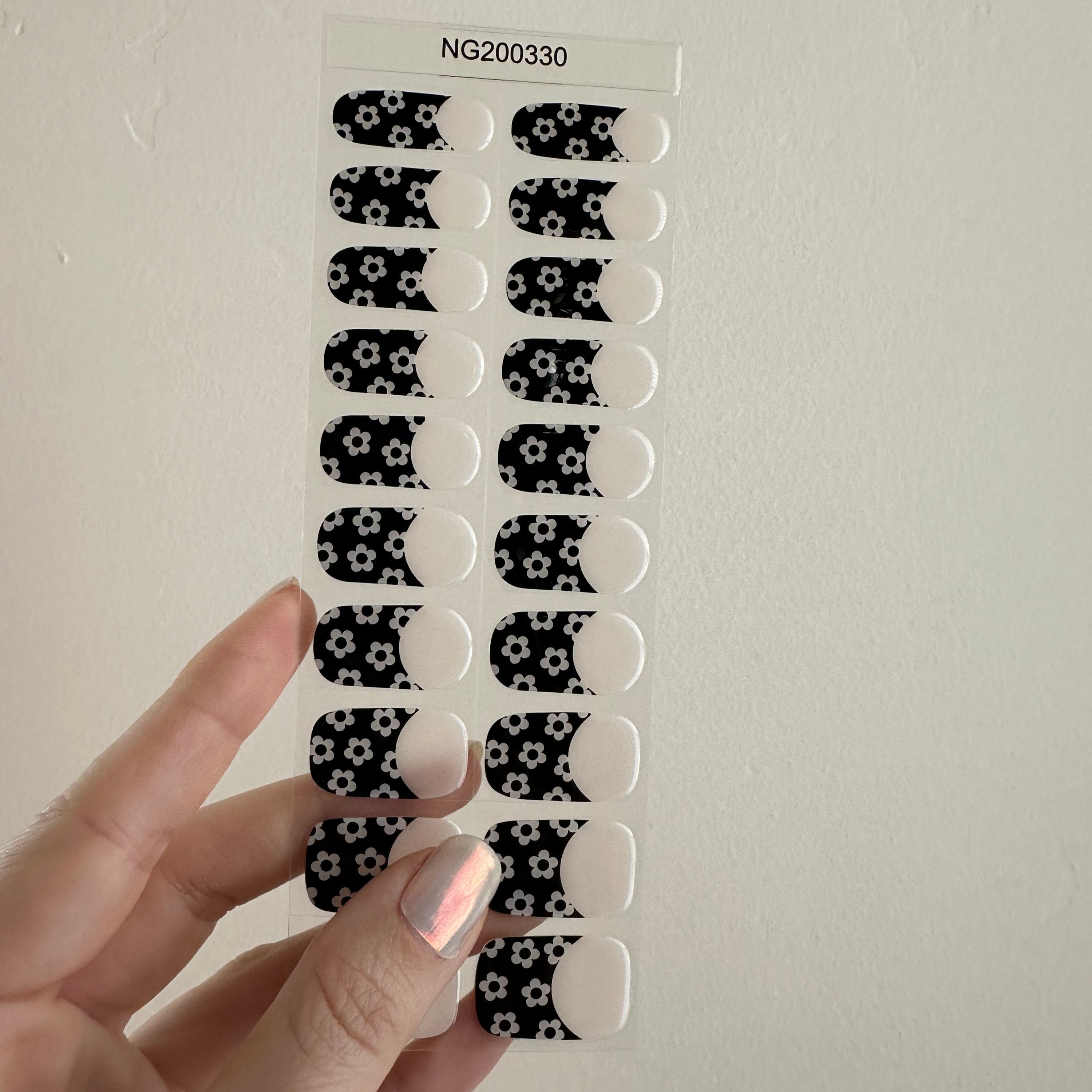 Semi-transparent creamy white with black and white french tips patterned with 60's mod style flowers!