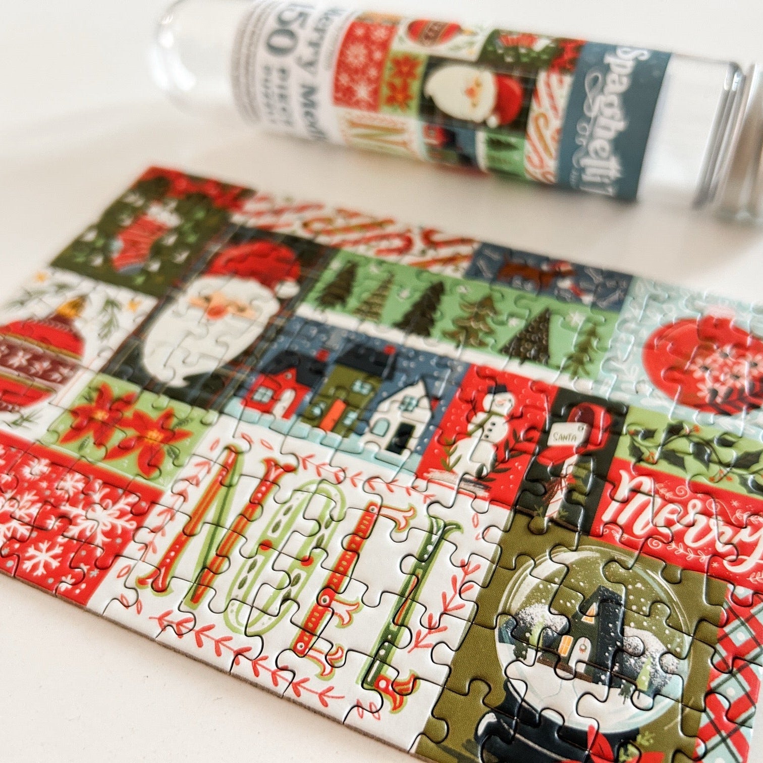 Completed puzzle with empty tube sitting in the background. 