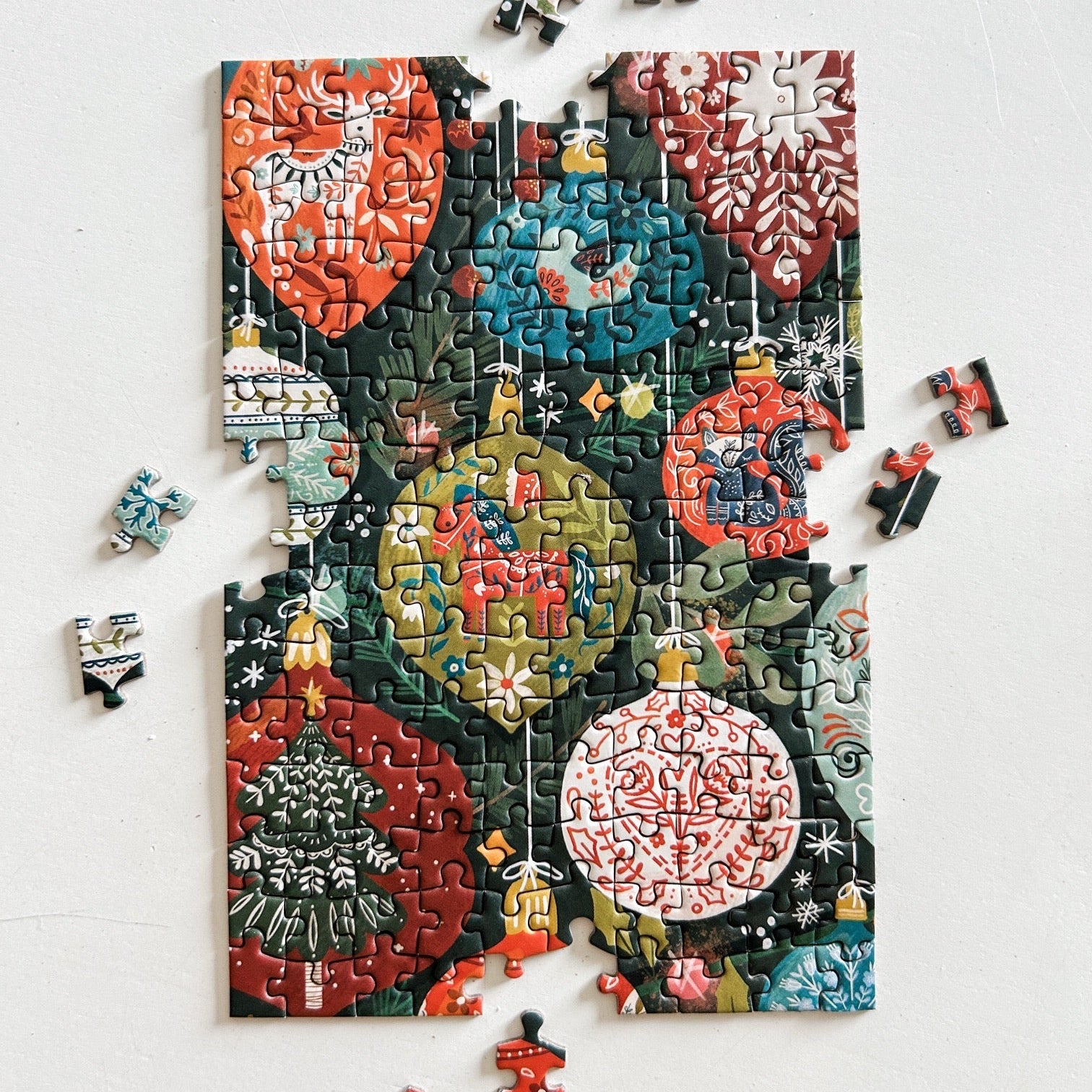 Partially finished mini ornament puzzle against a white background.