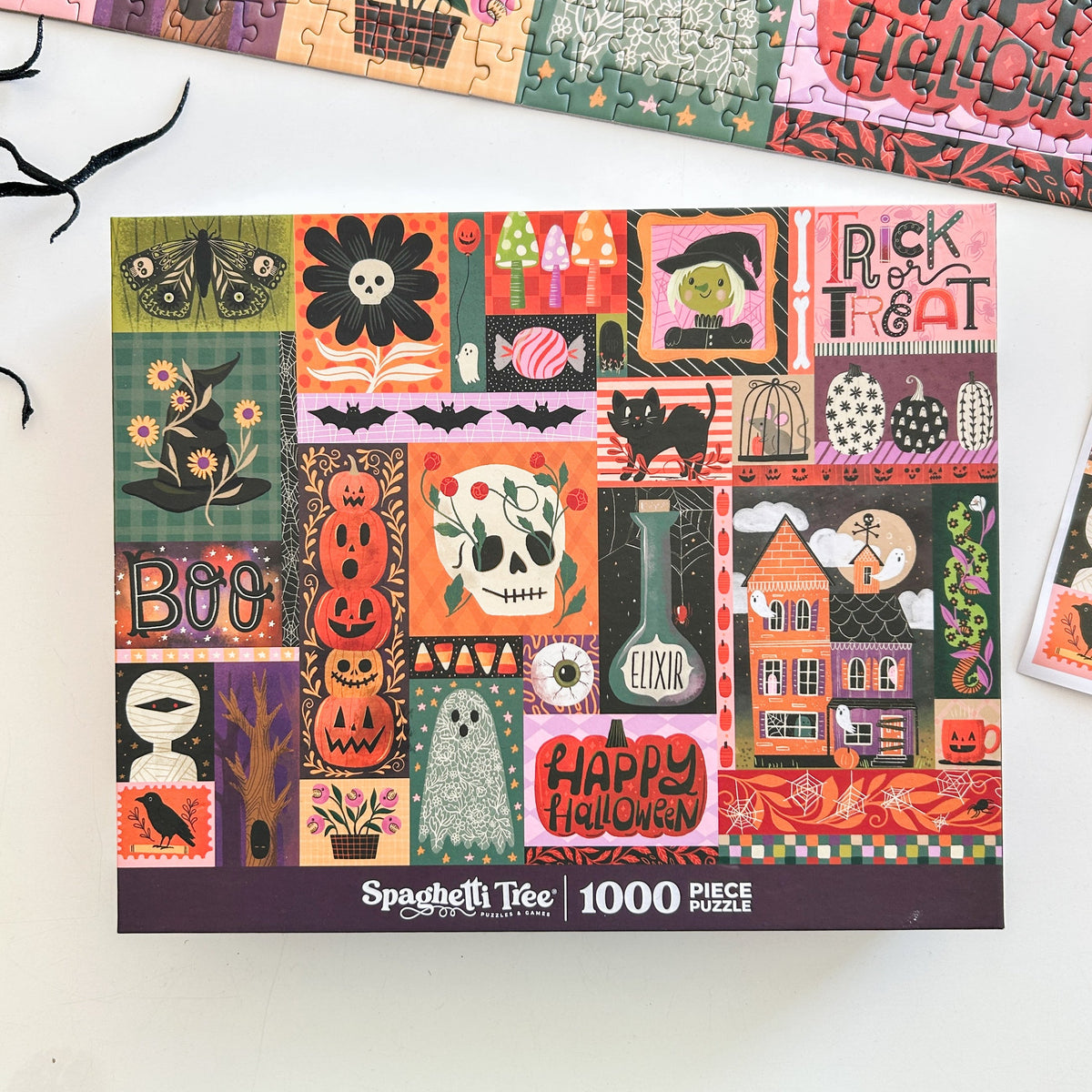 Above view of halloween puzzle. Patchwork style graphics of spooky halloween things like pumpkins, spiders, witches hat, ghost, ect. 