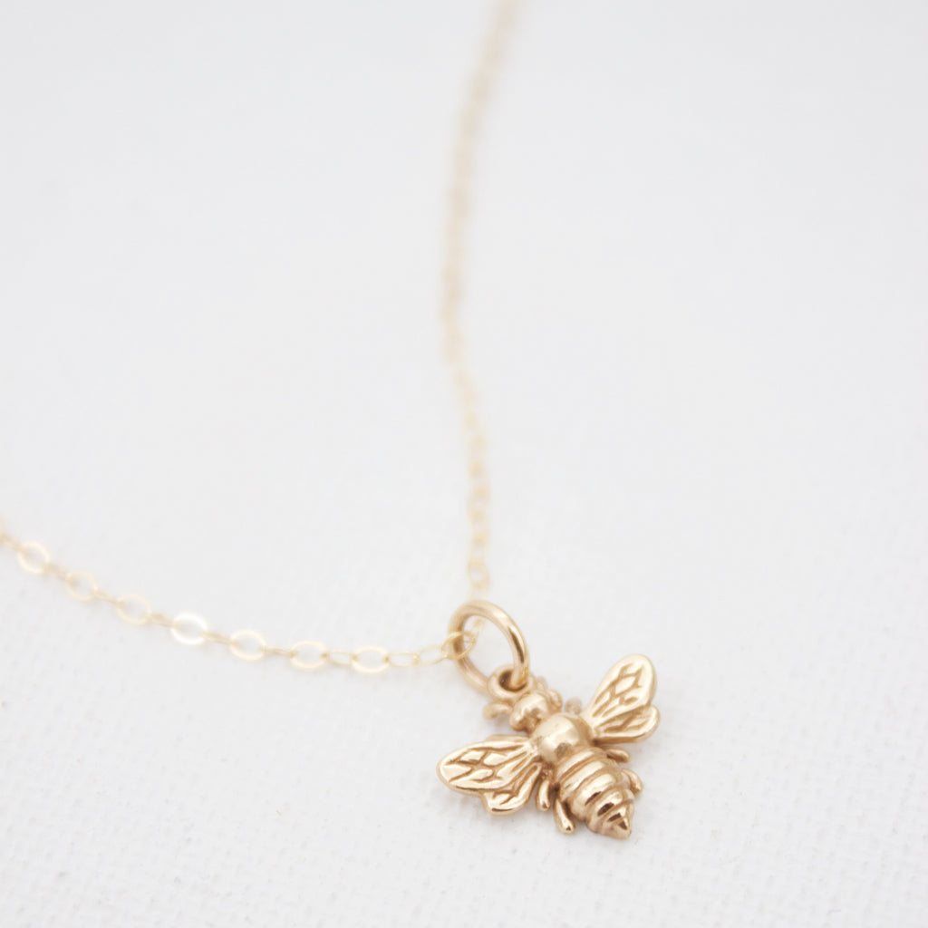 One of our best selling styles, the petite Bee Charm Necklace makes a great gift for all ages. Featuring a small bee charm an a 18" simple chain, you can't go wrong with this necklace!