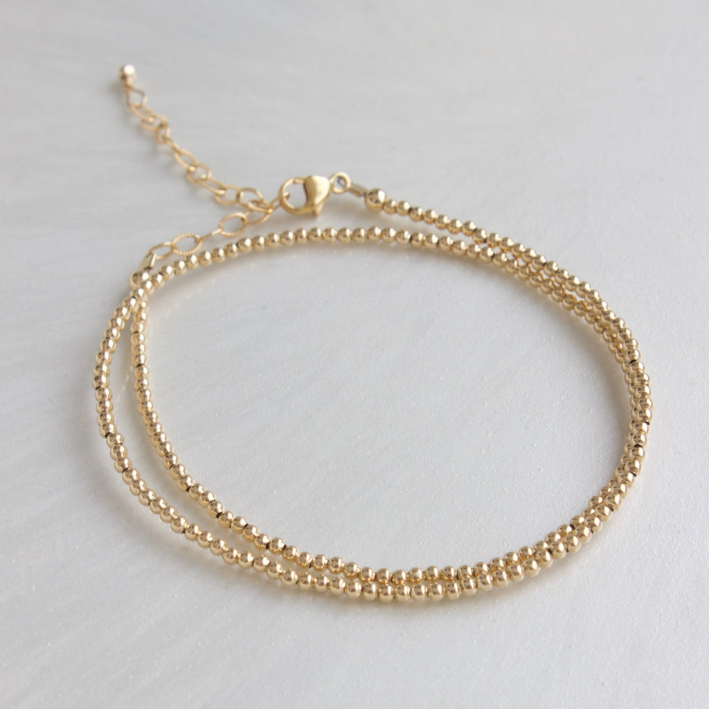Our double wrap bracelet is one of our number one best selling bracelets! The petite double wrap beaded bracelet features a 2mm bead that can be worn as a bracelet or a single layer choker necklace!