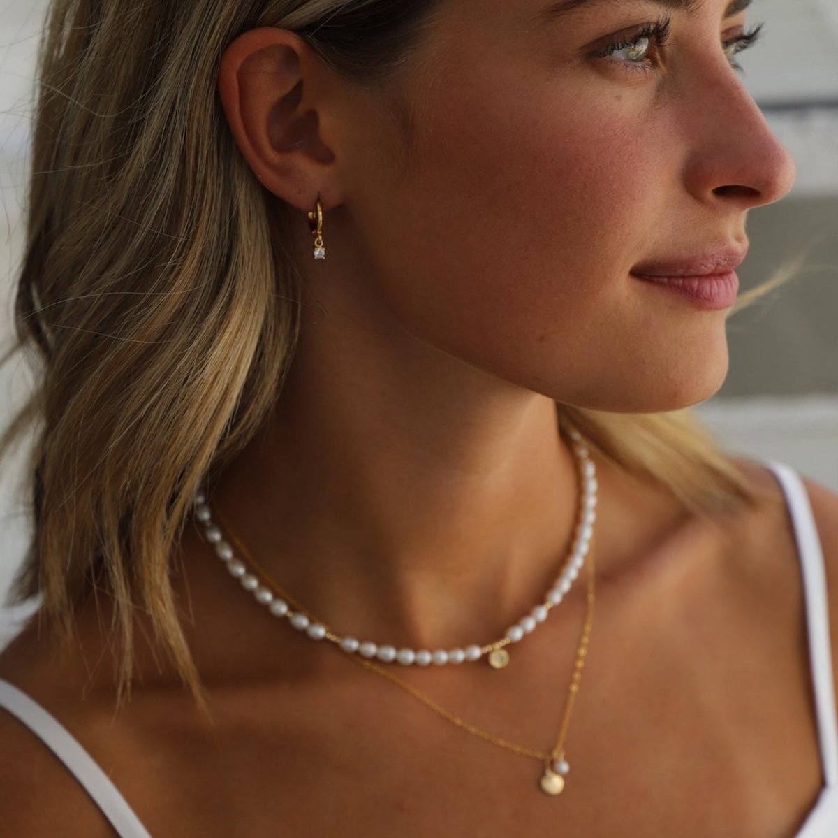 Sparkle all day with our Miniature CZ Drop Earrings! These huggie earrings feature delicate round cubic zirconia drops for a touch of elegance. Perfect for any occasion, these earrings will make you feel extra special.