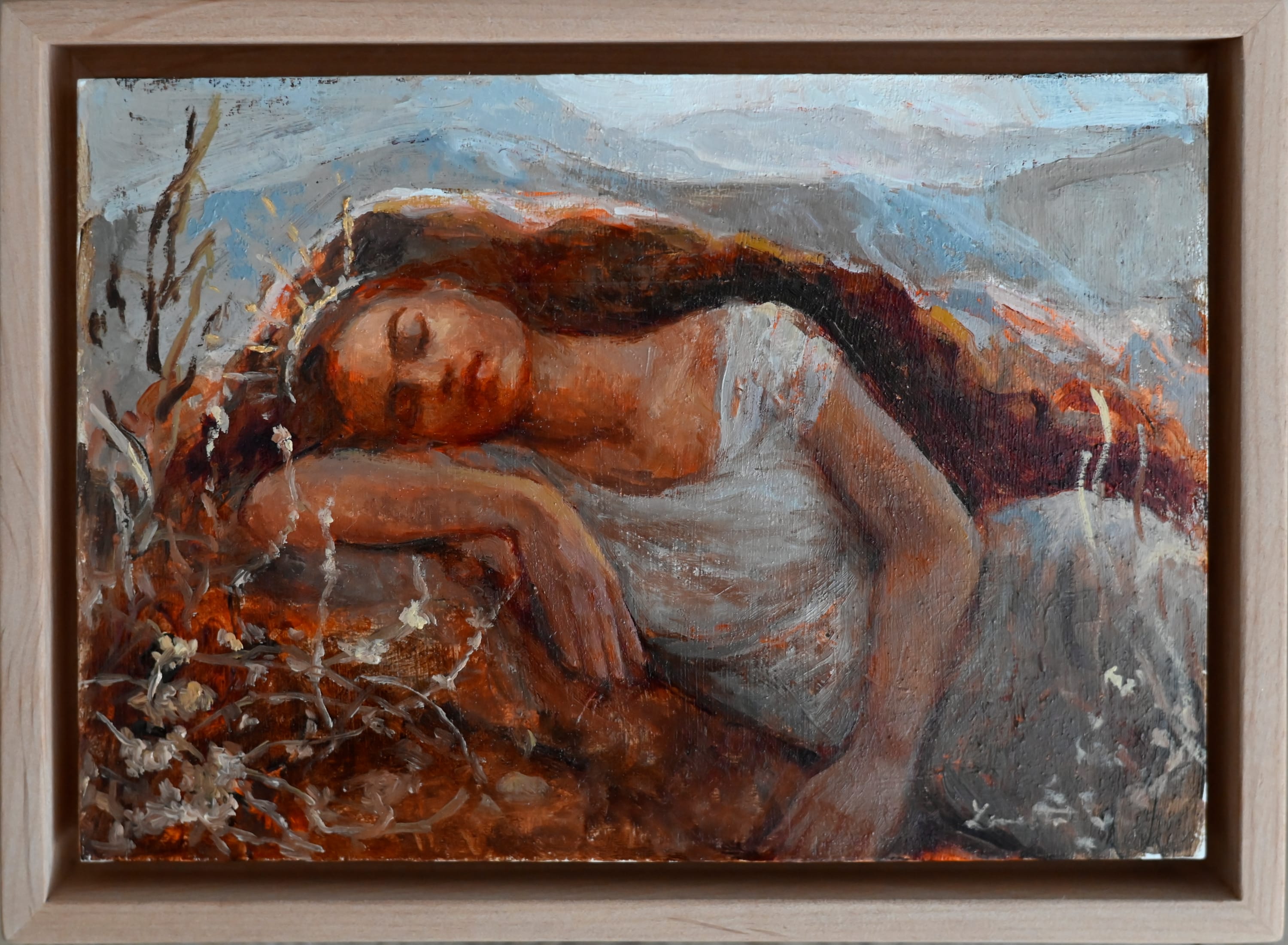 A depiction of Mother Earth - a woman wearing a white dress with long auburn hair and wearing a crown that looks like rays of sunshine - lays on her side with her eyes closed. Her head is resting on her right elbow and her left arm is in front of her torso. She seems to be sleeping, and in the foreground is flora of red and orange and white, and in the background is a hazy sky. 