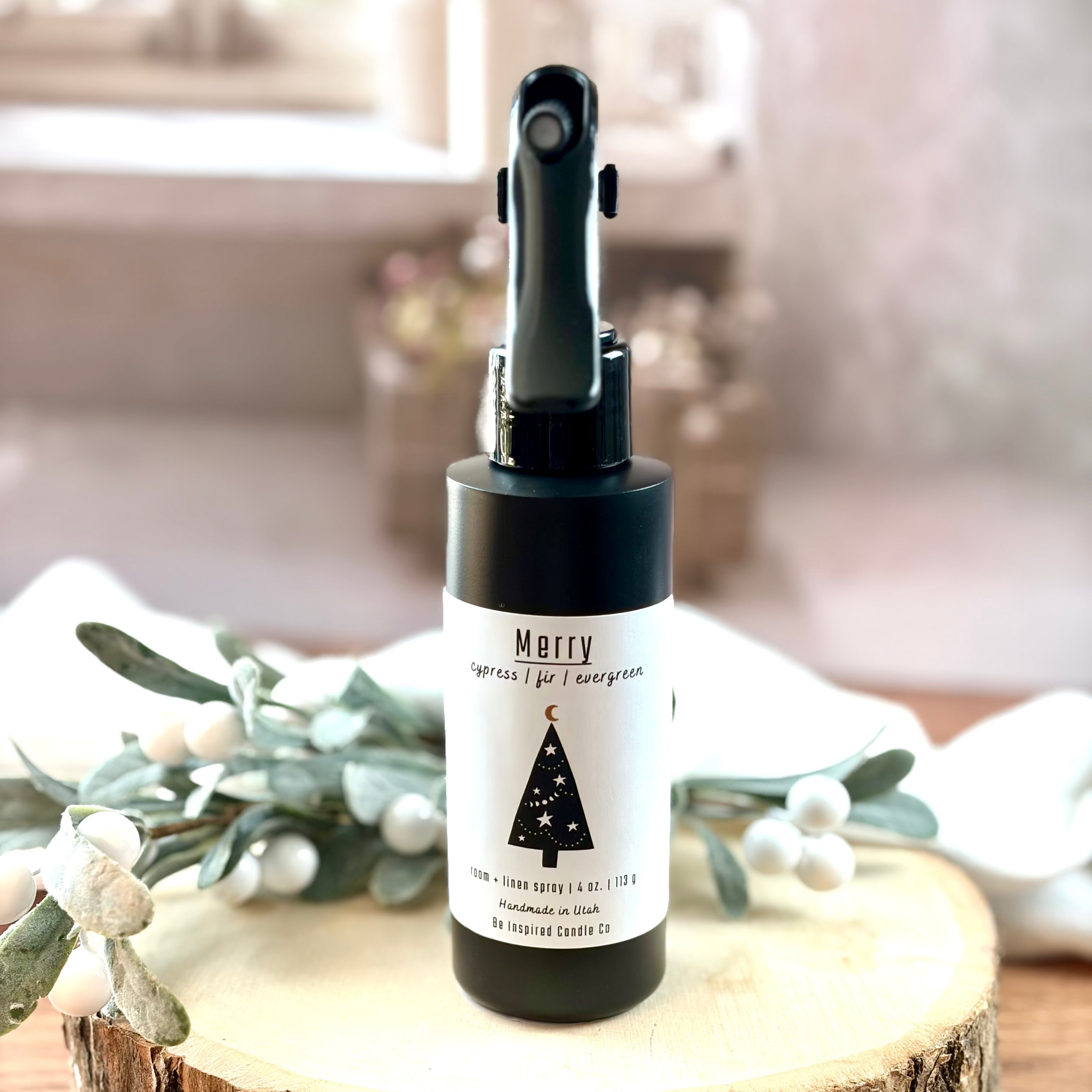 Black room spray bottle with white label.