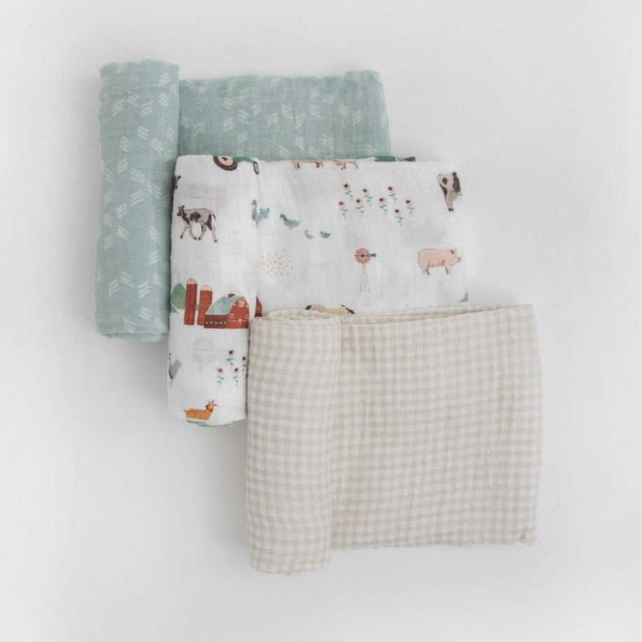 One to swaddle, one to cuddle, one to nurse! Featuring three hand-painted prints that fit your unique style, our swaddles are crafted in lightweight and breathable cotton muslin and get softer with every wash. Cotton Muslin Swaddle Blanket Set - Farmyard.      Materials  100% cotton muslin.  Loose weave that breathes and keeps your little one the perfect temperature.