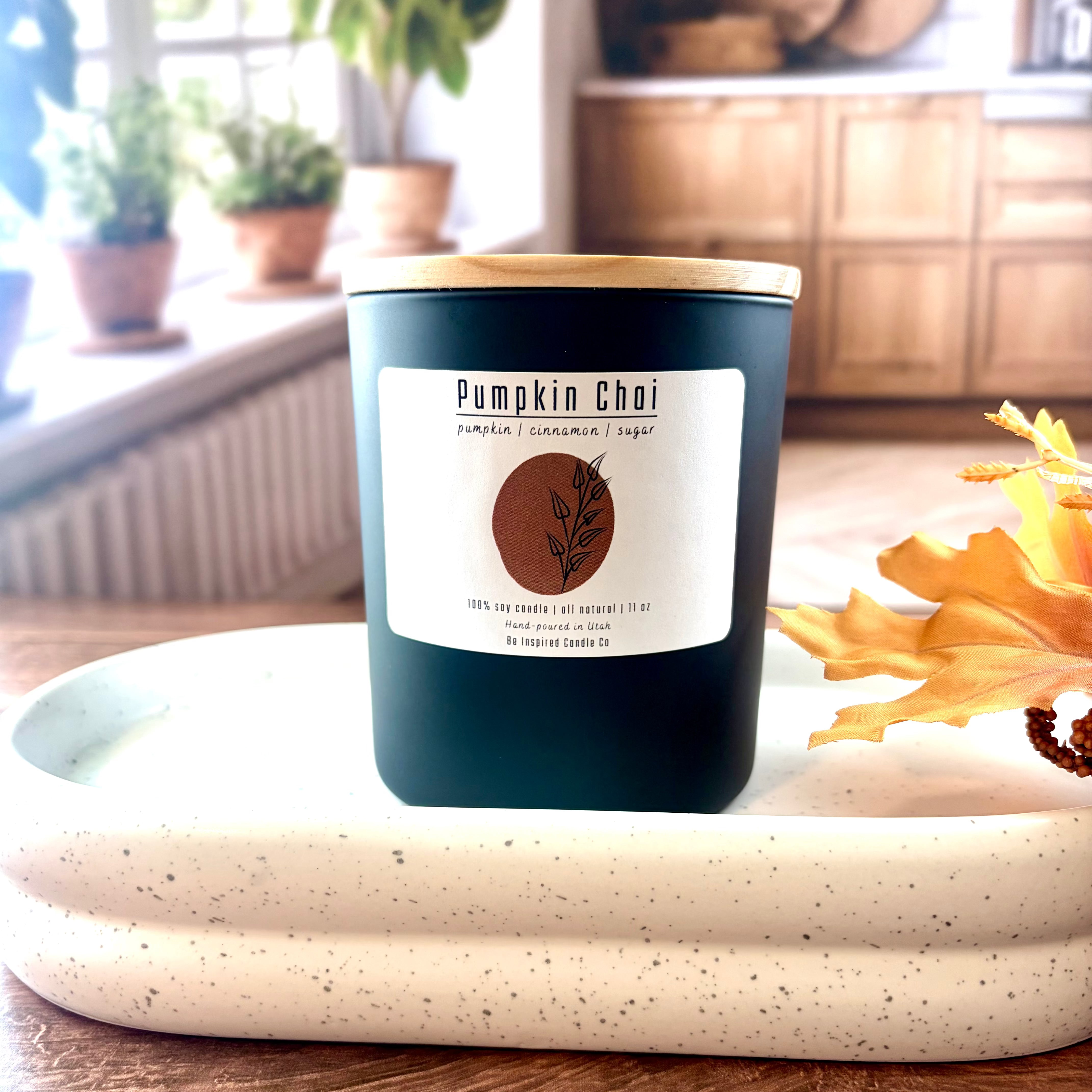 Large black ceramic candle with white label. 