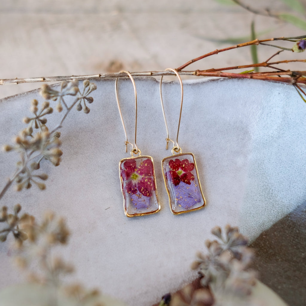 red and purple pressed flowers in gold rectangle bezels on hoops