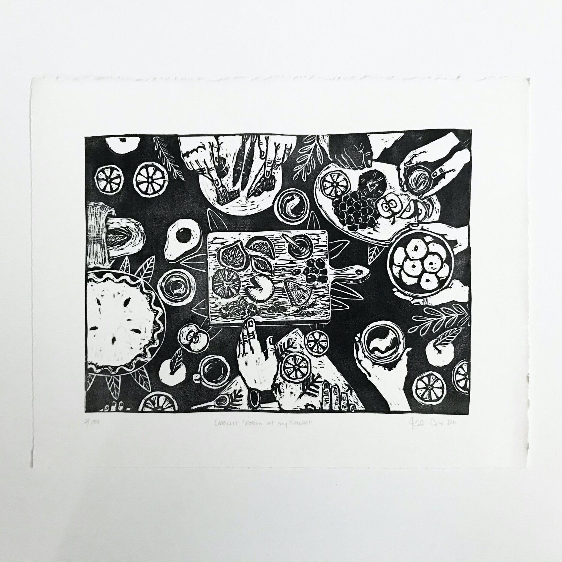 Hand carved and pressed print of a dinner table featuring a wide variety of foods