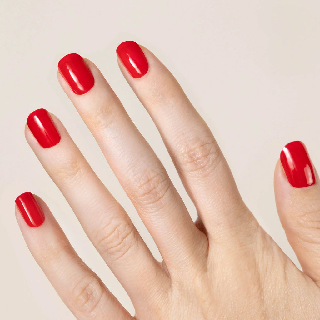 cherry red gel nail strip set on models hand