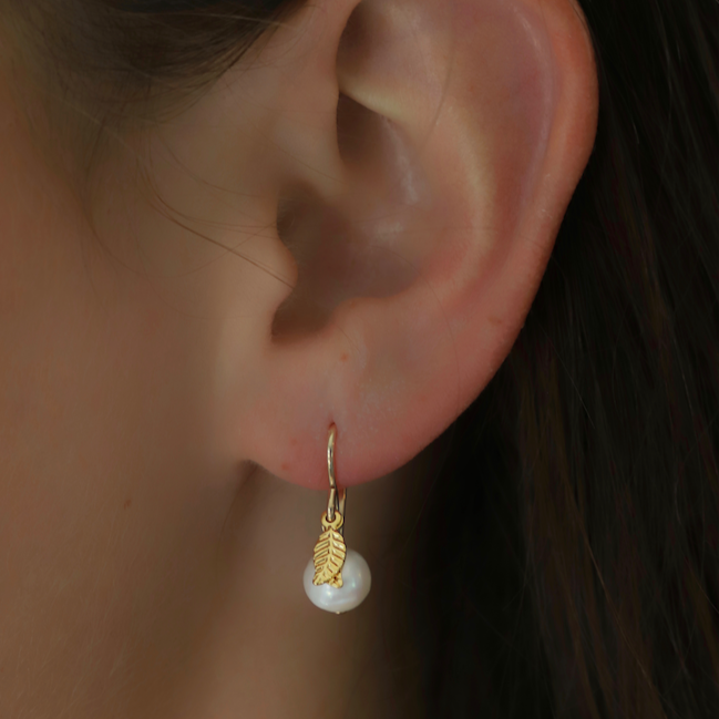 Small round white Austrian crystal pearl on our simple gold filled ear wires with gold leaf accents.