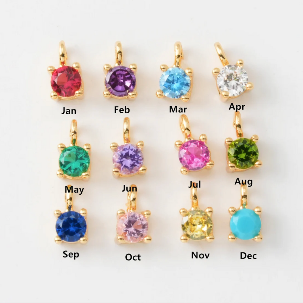 This beautiful birthstone charm bracelet features a delicate gold chain and a unique birthstone charm, making it a perfect piece for a personalized gift or a special piece for yourself. 