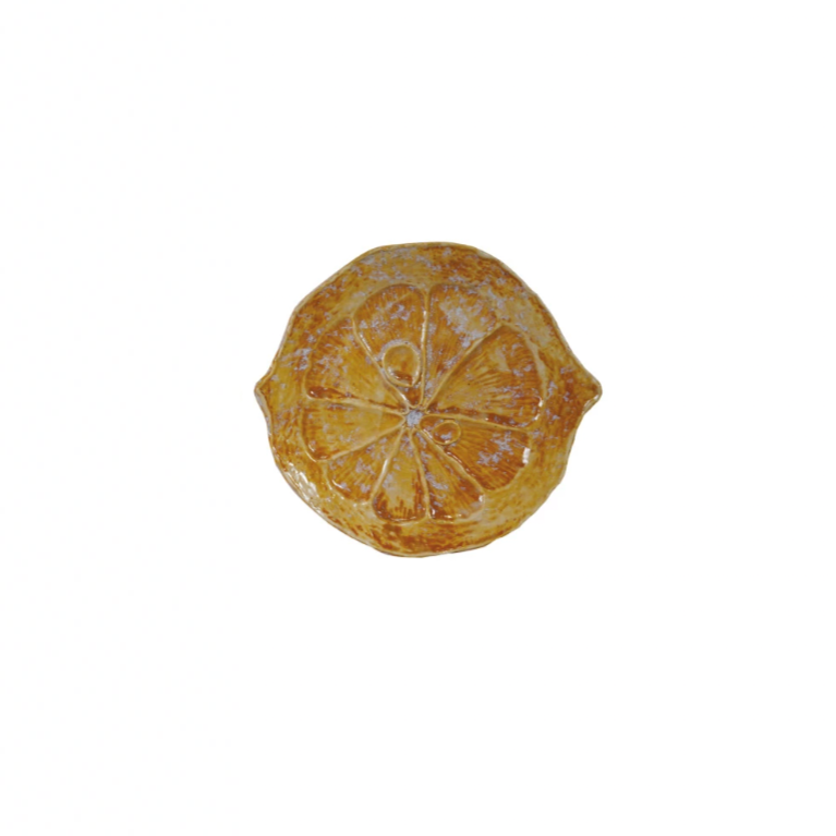 Brighten up your table with our Stoneware Citrus Shaped Plate! Available in 3 vibrant colors, this playful and quirky plate will bring a pop of fun to any meal. Made from durable stoneware, it's perfect for serving up all your favorite dishes. Add a slice of happiness to your dining experience today! 6-3/4"L x 6"W. Yellow