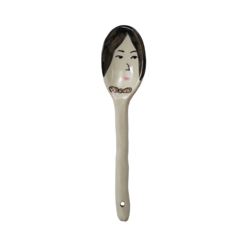 Spice up your cooking with this hand-painted stoneware spoon! Expressing personality with a playful face, this spoon adds charm and uniqueness to your kitchen tools. Perfect for stirring a little fun into your dishes. Black hair, bow tie