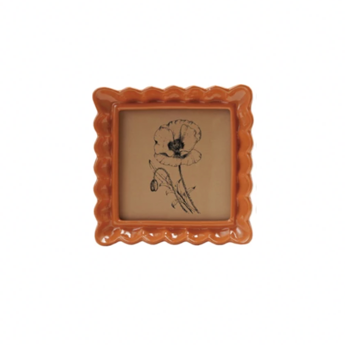 Display your memories with a twist in our Resin Wavy Photo Frame! Its unique design adds a playful touch to any space. Available in 4 fun colors, this frame is sure to make your photos pop! Perfect for those who love to add a little quirk to their decor. 5-1/4" Orange