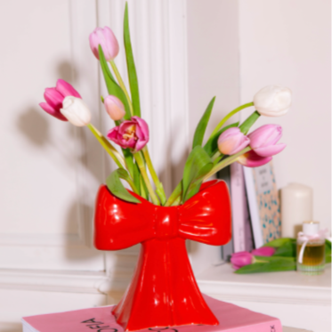 Ceramic vase shaped as a bow, taking inspiration from the ethereal ballet world and the whimsical allure of coquetry.