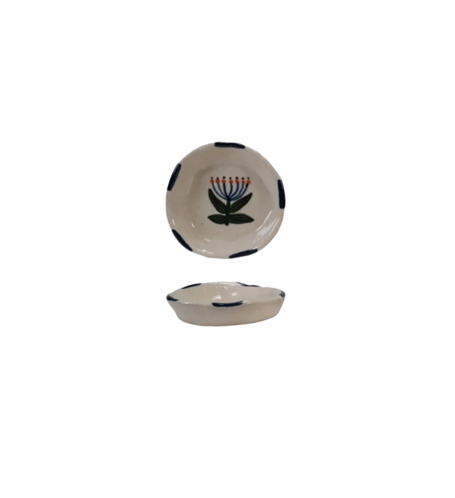 This hand-painted stoneware dish combines artistry with everyday functionality. Crafted with care, its unique design adds a personal touch to your table while providing a durable surface for serving your favorite meals. Perfect for those who appreciate handmade quality and want to bring warmth and character to their dining experience. 3-1/4" Round