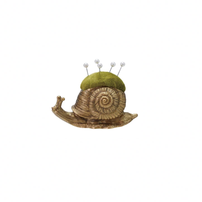 Add a touch of whimsy to your sewing kit with this Snail Velvet Pin Cushion! Soft velvet forms the charming snail shape, making it both adorable and practical. It comes with five pearl head pins, perfect for keeping your needles handy and stylish. Brighten up your crafting space with this playful and functional companion. Approximately 3"L
