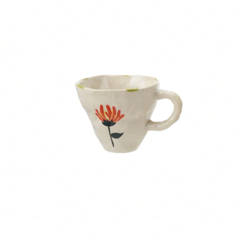 Brighten your day with this charming hand-painted stoneware mug, featuring a delightful whimsical flower design. Perfect for sipping your favorite brew, it adds a splash of joy and a touch of nature to every coffee break. Durable and unique, this mug turns ordinary moments into playful celebrations. 10 oz. 4-1/2" Round x 3-1/2"H