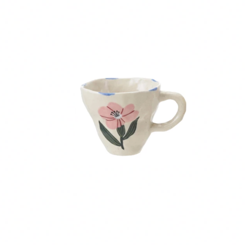 Brighten your day with this charming hand-painted stoneware mug, featuring a delightful whimsical pink flower design. Perfect for sipping your favorite brew, it adds a splash of joy and a touch of nature to every coffee break. Durable and unique, this mug turns ordinary moments into playful celebrations.&nbsp;10 oz. 4-1/2" Round x 3-1/2"H