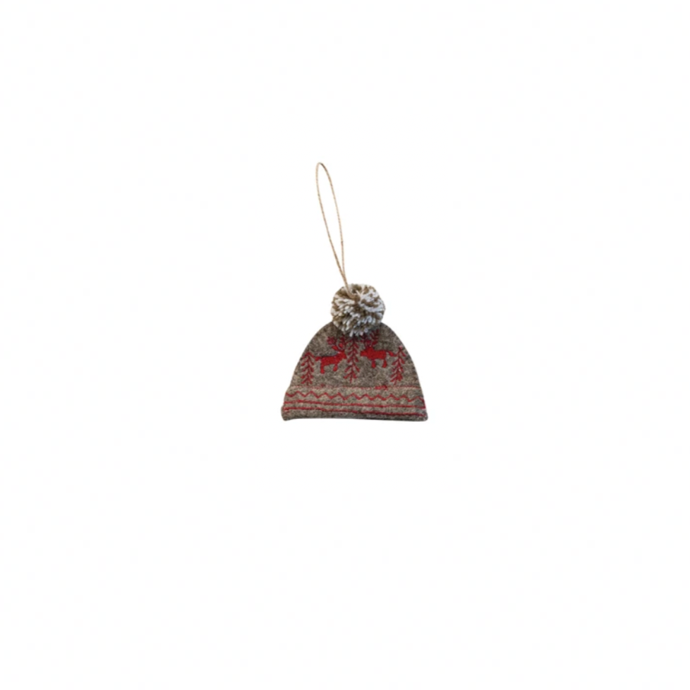 Small knitted hat ornament with a pom-pom on a white background