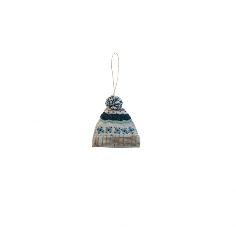 Knitted hat ornament with pom-pom on a white background