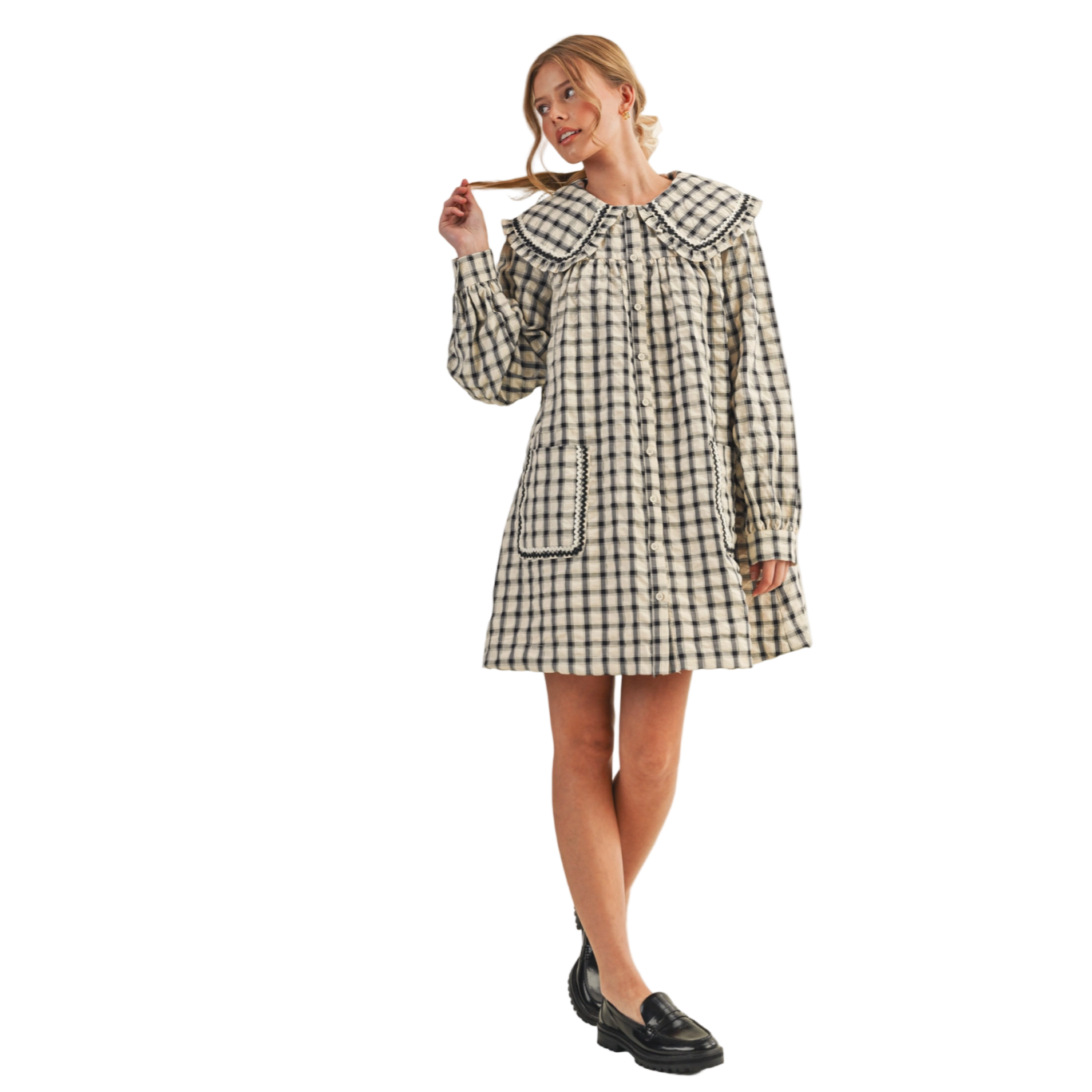Woman wearing a black and white checkered dress on a beige background