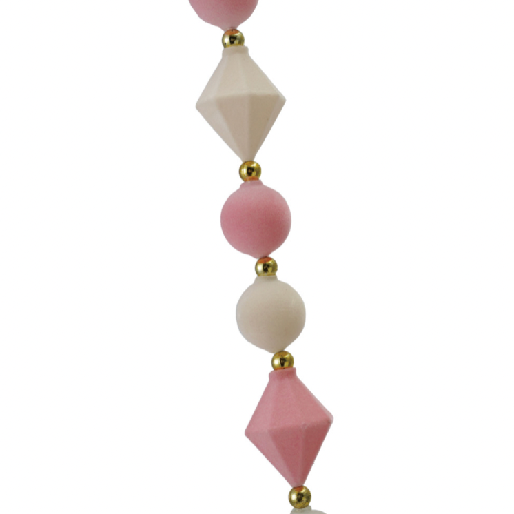 Decorative hanging with pink and white geometric beads on a white background