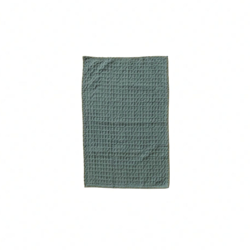 Green textured towel on a white background