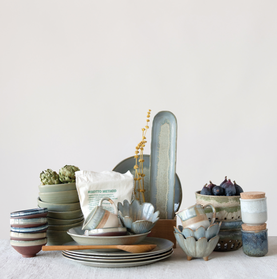 Collection of ceramic dishes and items on a light surface with a neutral background