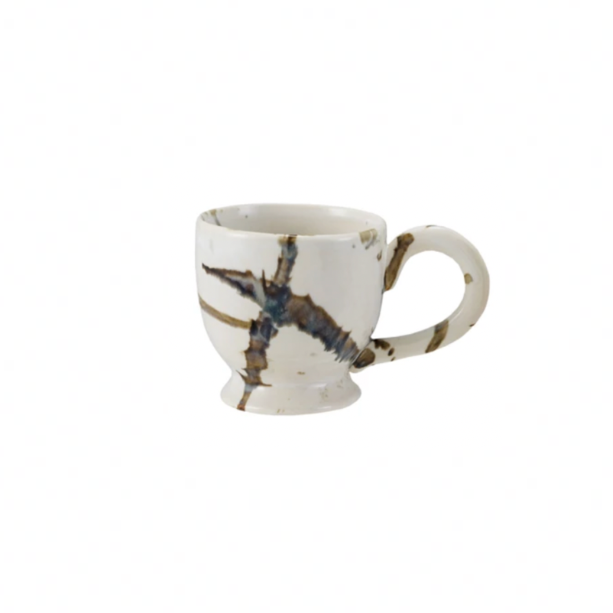 White mug with brown abstract design on a white background
