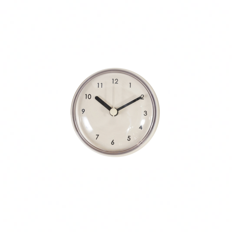 Beige Round wall clock with black hands on a white background. 