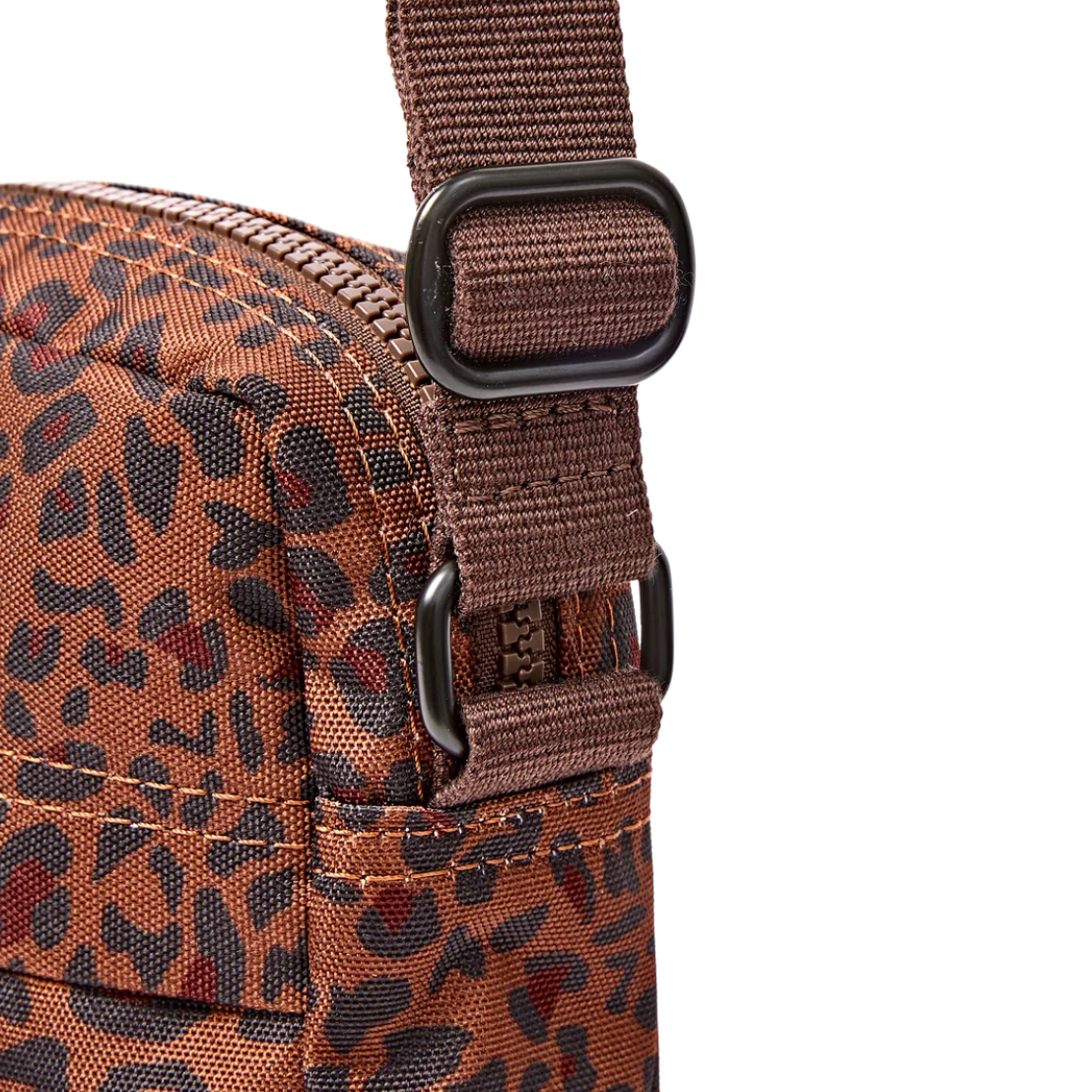 Close-up of a brown and black leopard-print fabric pouch with a matching brown webbed strap and black metal hardware on a white background.